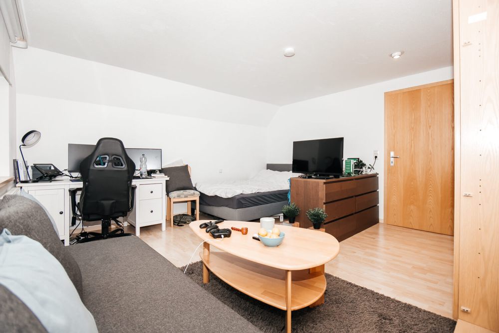 Großes Studentenzimmer mit Schreibtisch, Bett und Fernseher im Studentenwohnheim City in Furtwangen